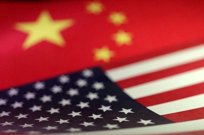 U.S. and Chinese flags illustration — FCC adds Chinese robots to national security Covered List
