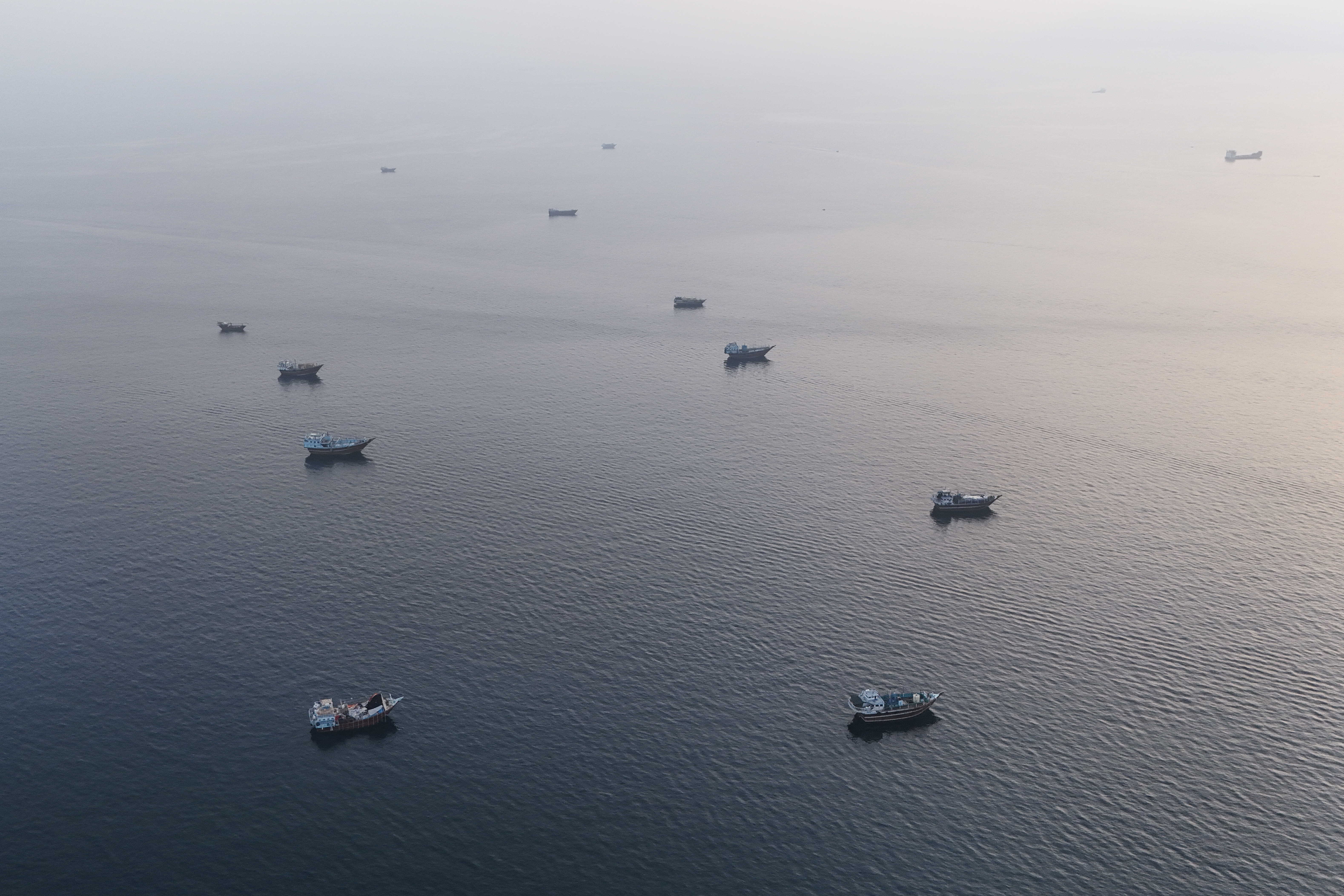Boats anchored off Oman Musandam Peninsula near the Strait of Hormuz as shipping recovers amid Iran peace talks July 2026