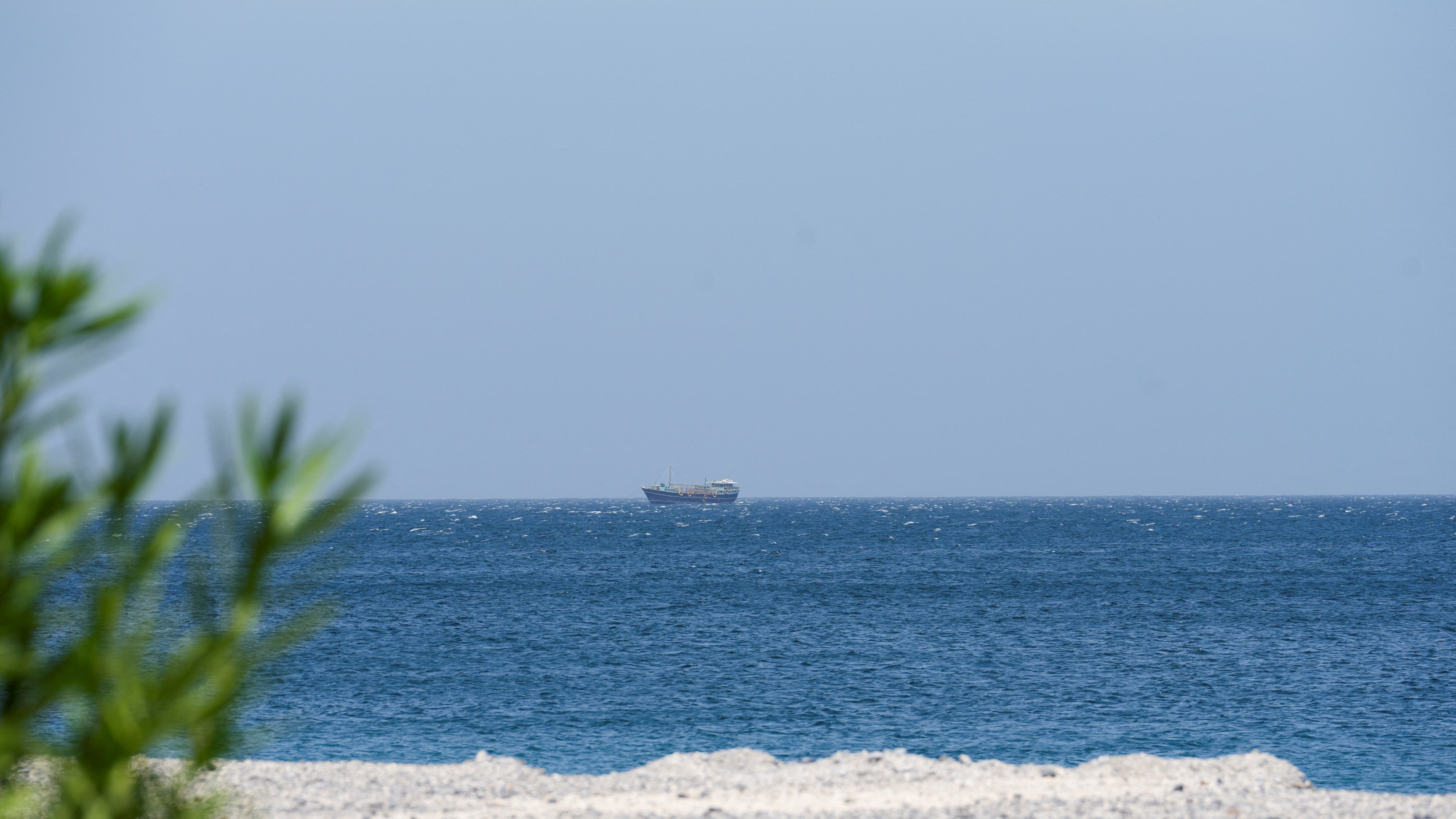 A vessel near the Omani coast as the Strait of Hormuz remains partially blocked by mines, April 2026