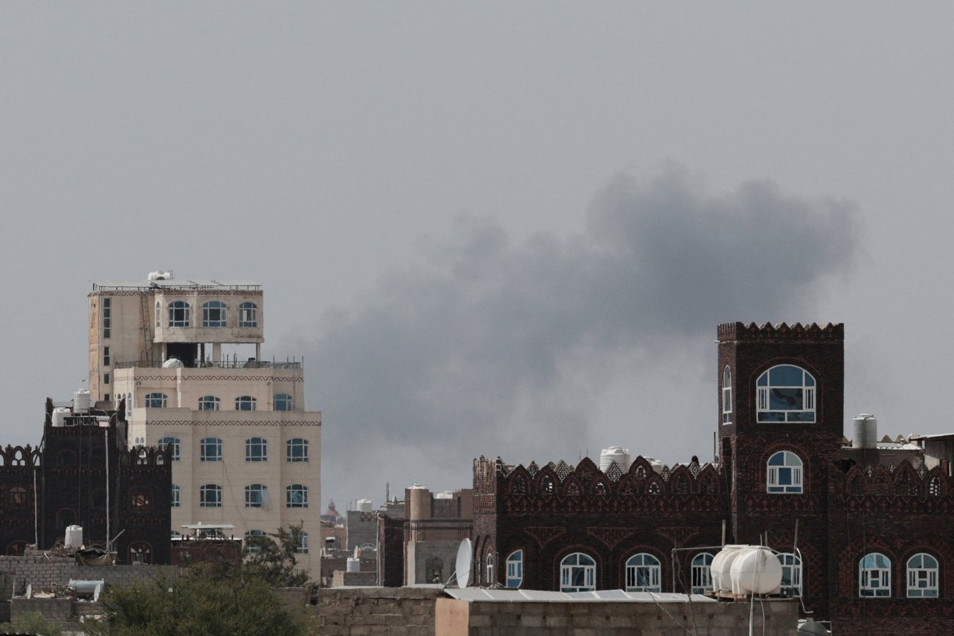 Smoke and damage at Sanaa International Airport after the Yemeni government struck the runway on July 13, 2026, triggering Houthi retaliatory missile and drone strikes against Saudi Arabia's Abha airport