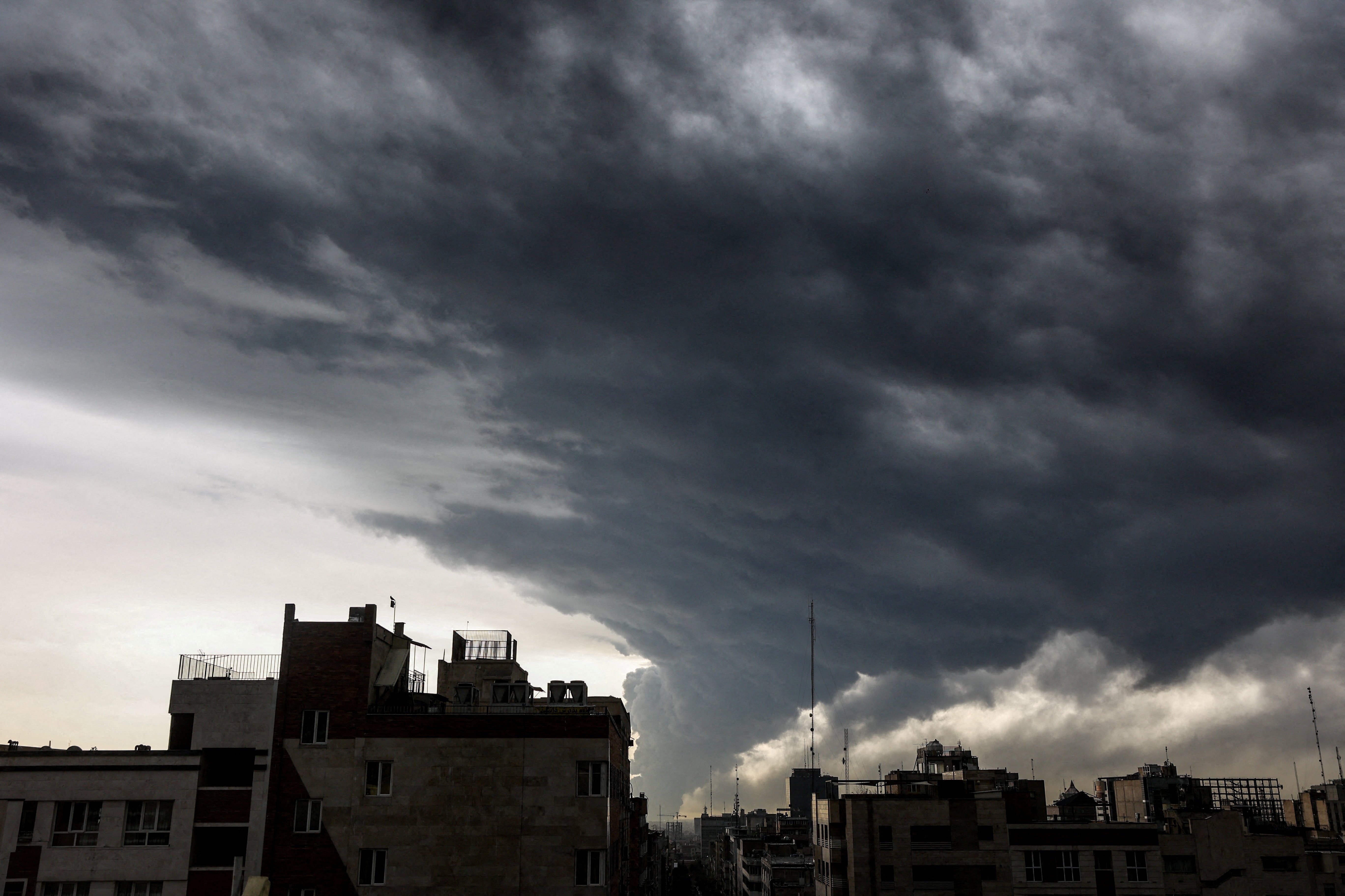 Plumes of smoke rise from bombed oil storage facilities over Tehran, Iran, March 8 2026