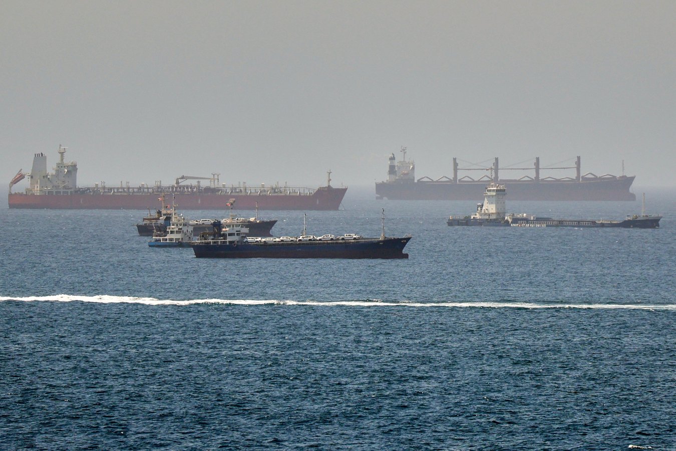 Rescue boats approach burning oil tankers in the Strait of Hormuz as the US carried out its tenth night of strikes on Iran