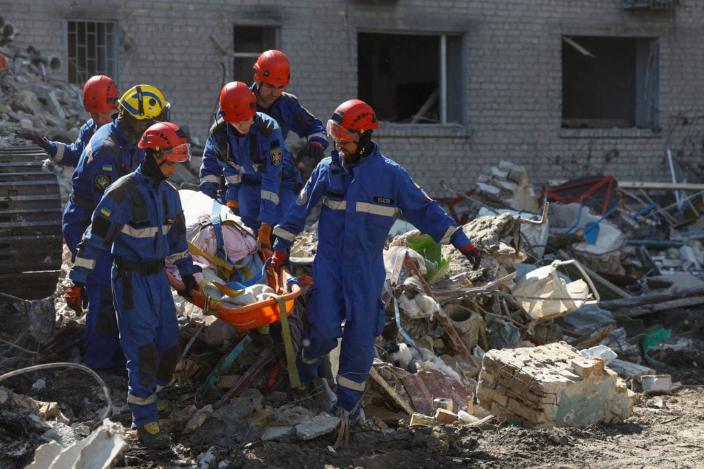 Emergency rescuers recover a victim from debris at a damaged apartment building in Kyiv's Darnytskyi district following Russia's overnight missile and drone attack, July 2, 2026
