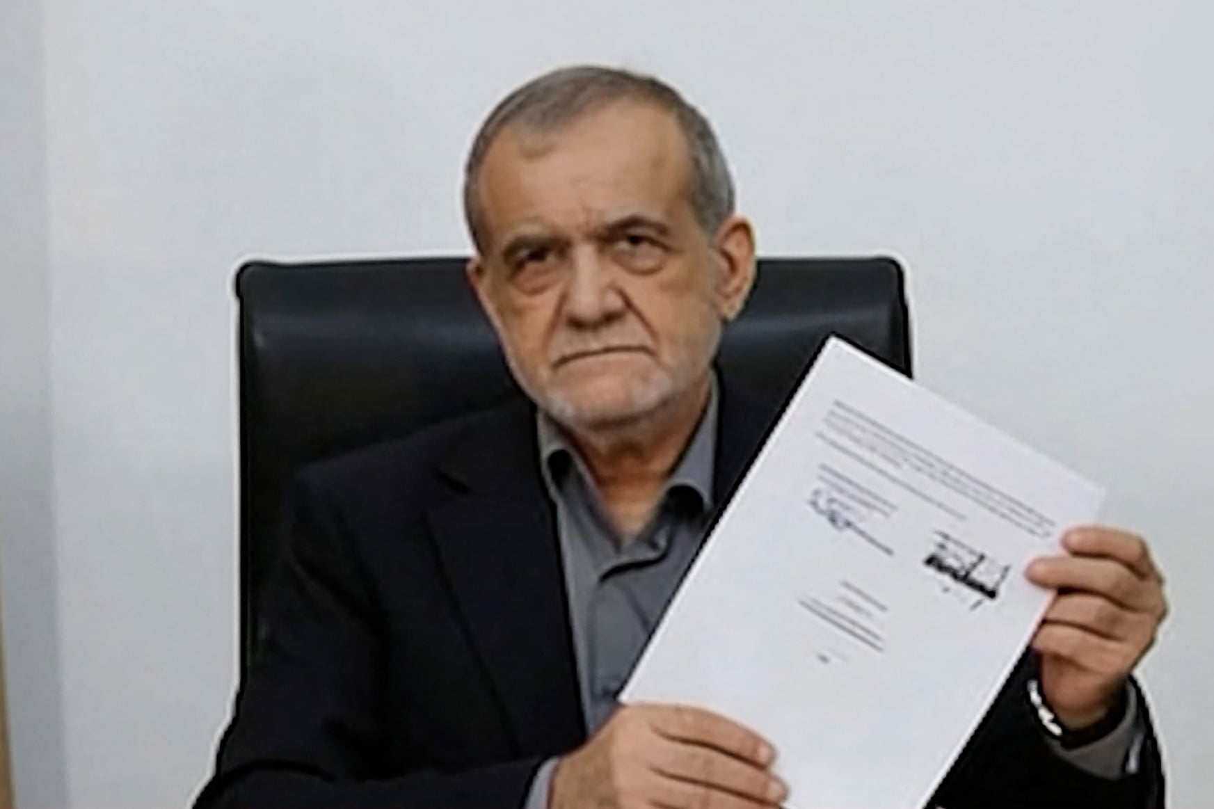 Iranian President Masoud Pezeshkian displays the signed Islamabad Memorandum of Understanding June 2026