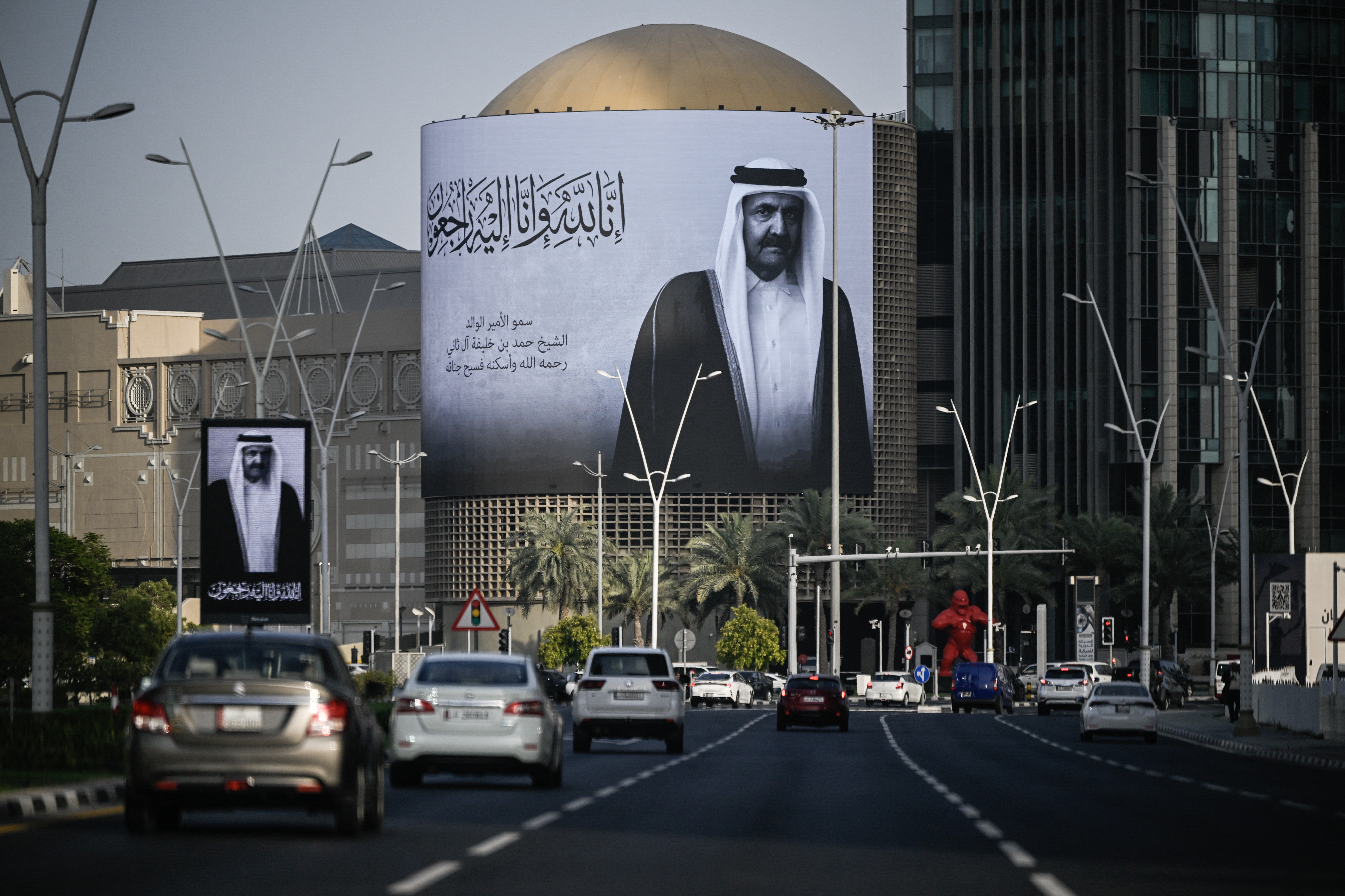 Memorial billboard portrait of Sheikh Hamad bin Khalifa Al Thani on a street in Doha, Qatar