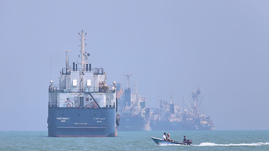 Commercial vessels navigating the Strait of Hormuz as Iran-US tensions escalate over Gulf ceasefire timing