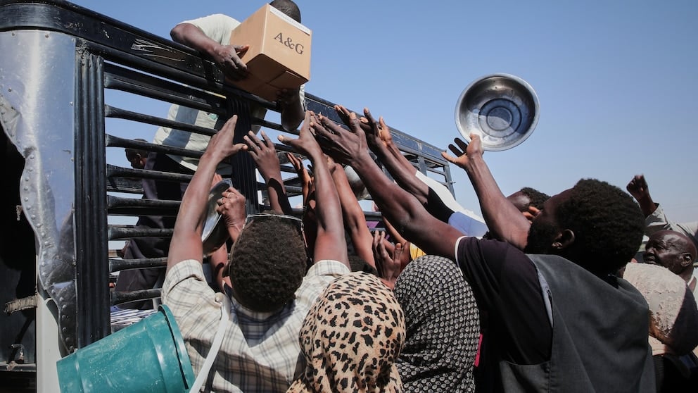Sudanese displaced families receiving food aid in Northern State Sudan