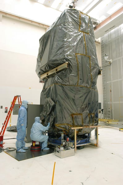 NASA technicians remove protective cover from Swift Observatory solar array at Cape Canaveral in 2004