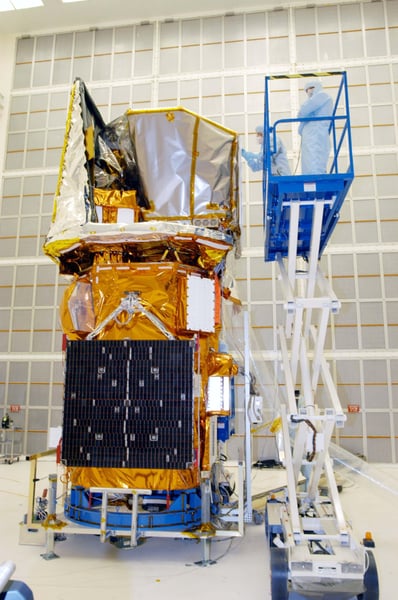 NASA technician performs thermal wrapping on the Swift Observatory spacecraft at Kennedy Space Center in 2004