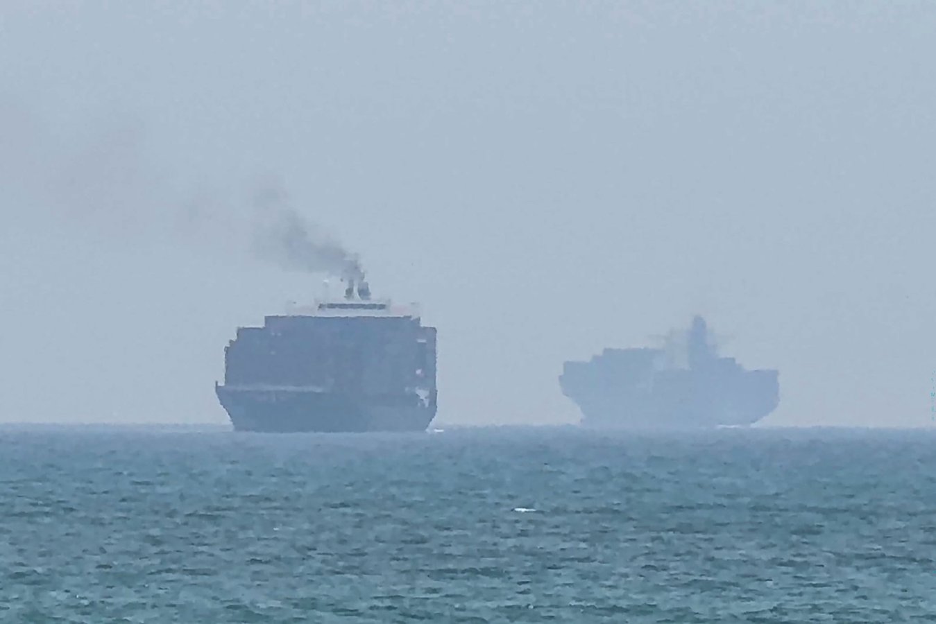 Commercial vessels navigate near the Strait of Hormuz off the UAE coast as the US reinstates the Iran naval blockade, July 2026