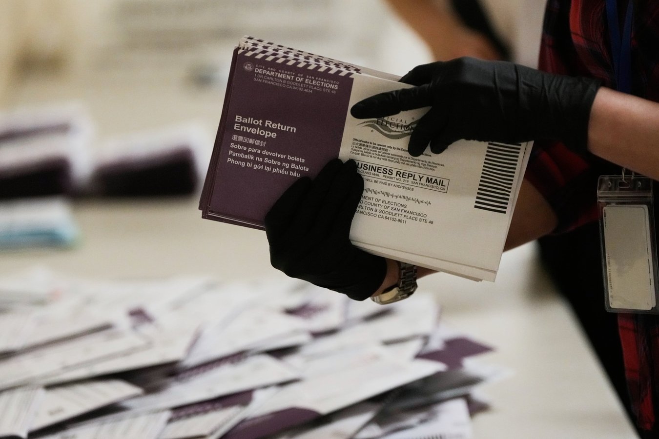 Election workers sort mail-in ballots at a San Francisco election office as the DC Circuit overturns the block on Trump's USPS mail-voting rule