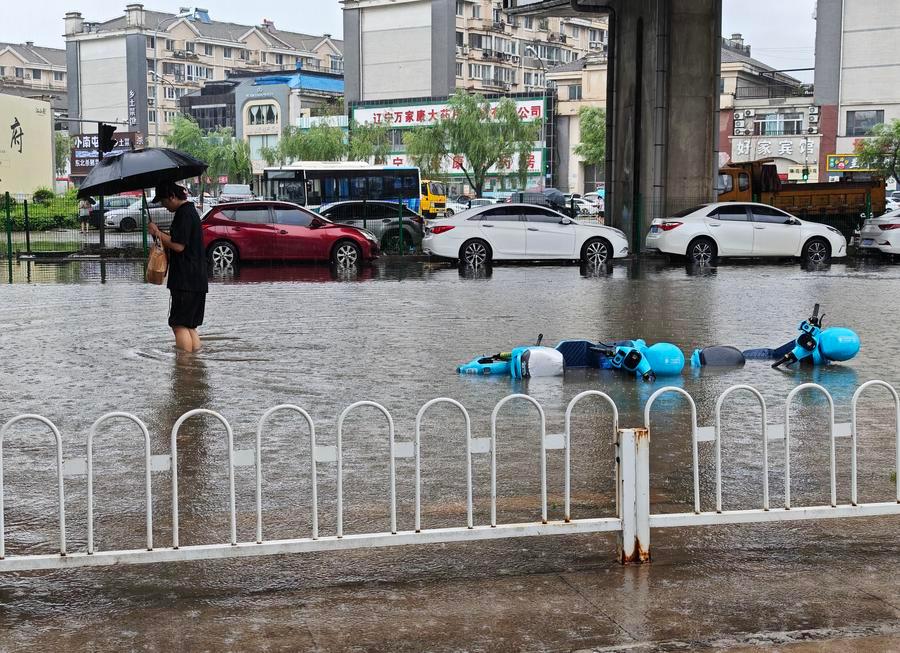 Emergency workers and evacuees during Typhoon Bavi flooding in northeast China