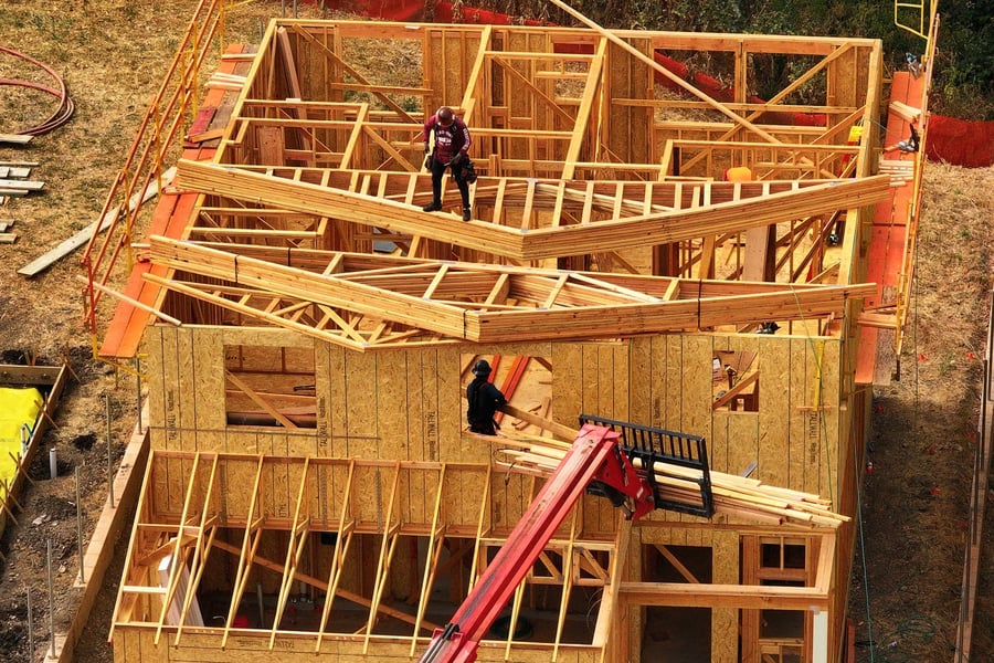 Construction workers building new single-family homes in the United States as housing affordability reaches historic lows