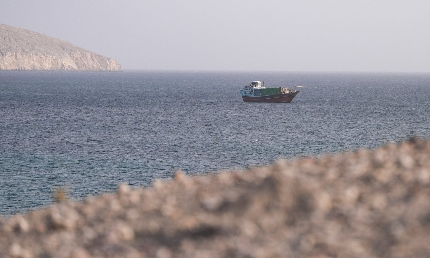 A vessel navigates the Strait of Hormuz as large commercial tanker traffic has nearly stopped amid US-Iran conflict in 2026