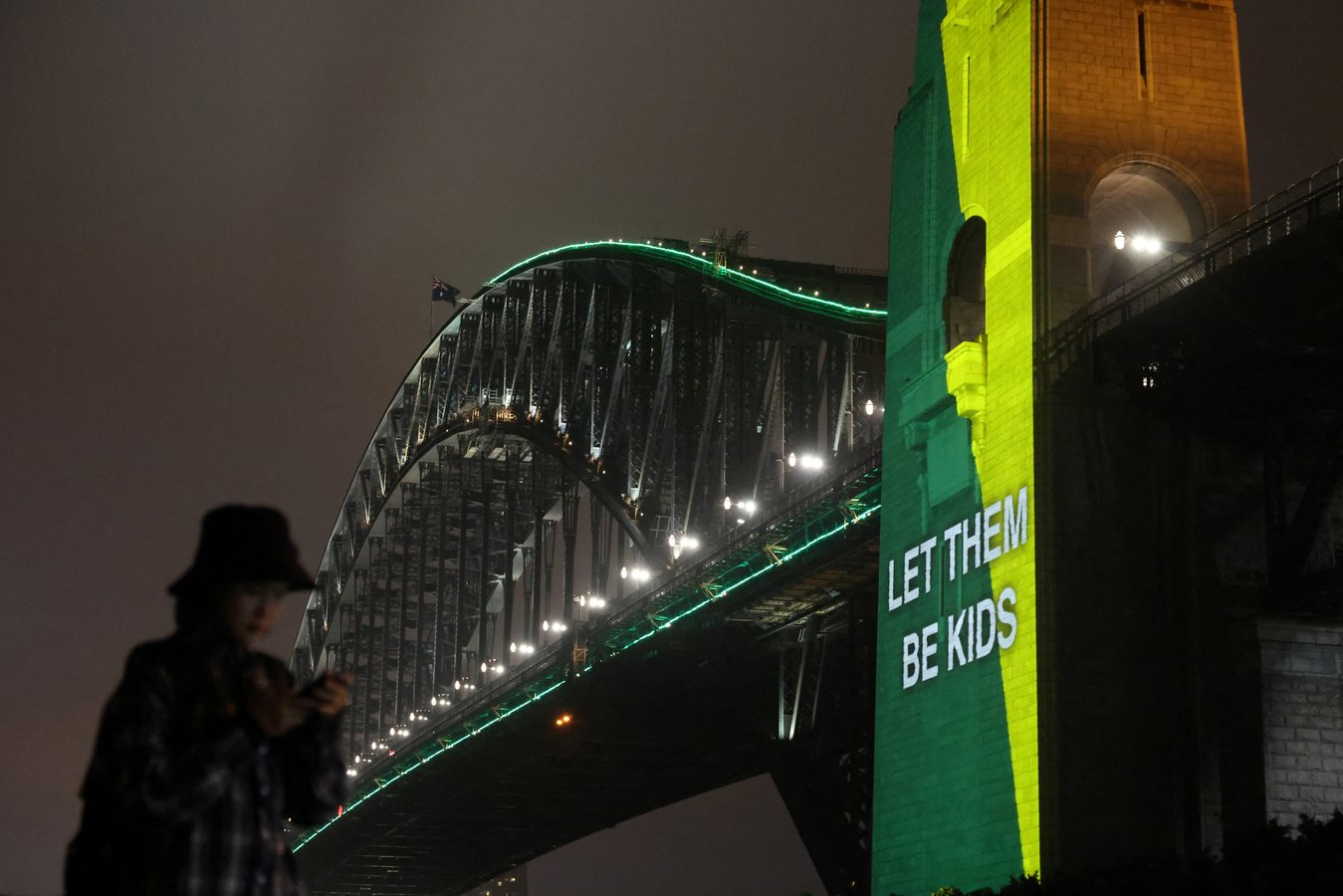 Sydney Harbour Bridge projected with Let them be kids message marking Australia social media ban for under-16s