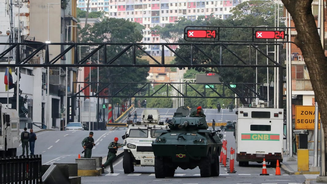 National Guard armored vehicles block an avenue near the Miraflores presidential palace in Caracas, Venezuela