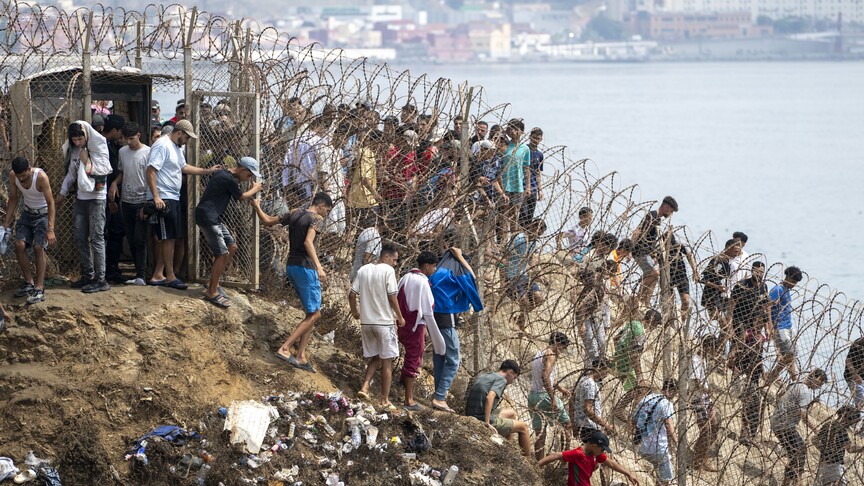 Migrants at the Ceuta border fence between Spain and Morocco during the August 2026 crisis