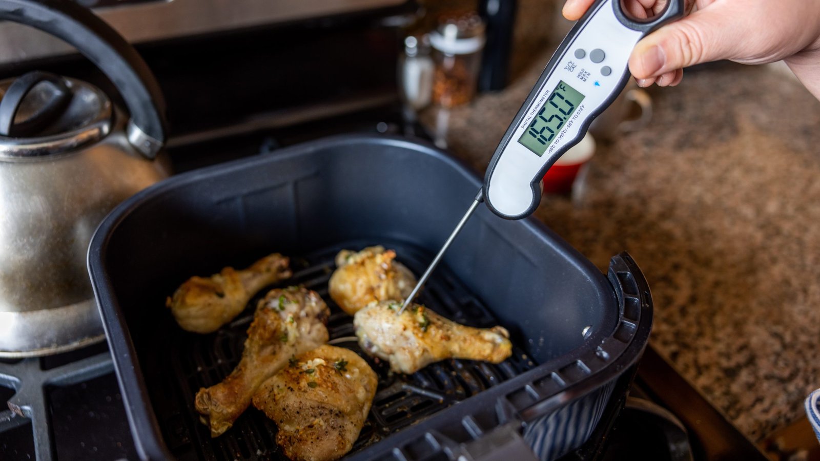 Food thermometer inserted into cooked food to check safe temperature, CDC salmonella food safety