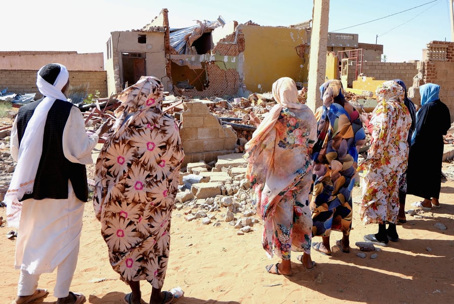 People praying amid rubble after drone strike in el-Obeid, North Kordofan, Sudan