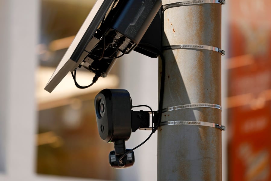 A Flock Safety automated license plate reader camera mounted on a roadside pole