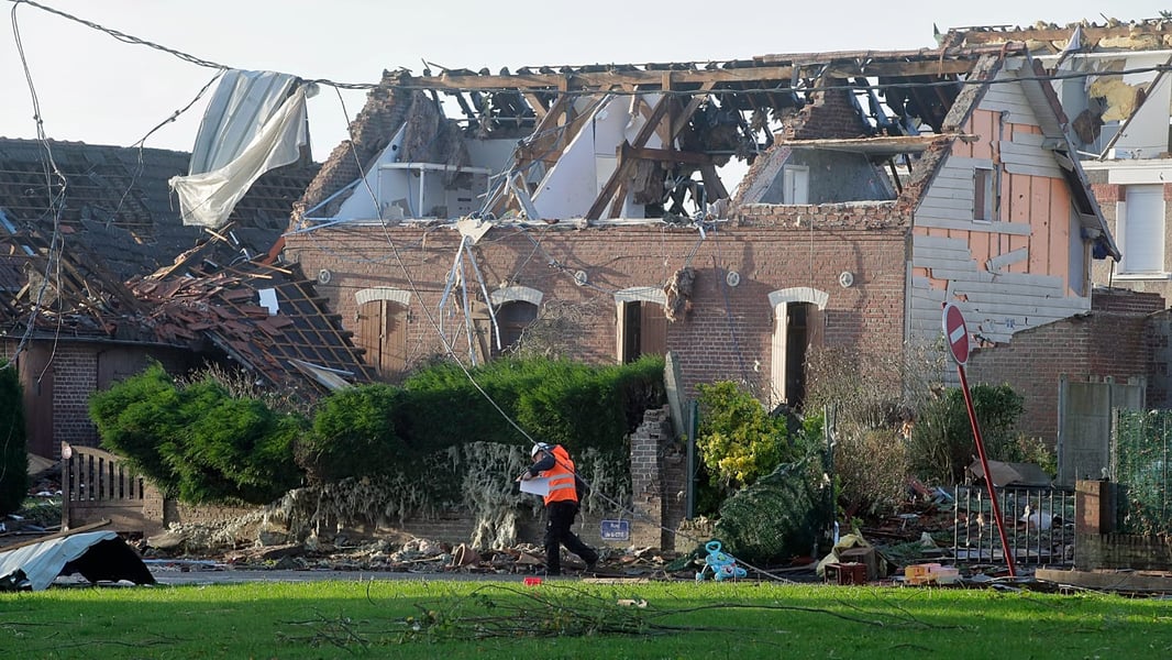 A rescue worker assesses tornado damage to homes in northern France in a file photo showing the type of destruction tornadoes cause in French communities