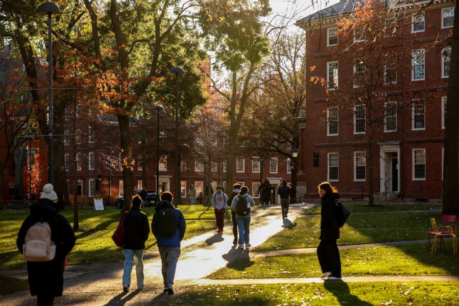 Students walking on Harvard University campus in Cambridge Massachusetts amid Trump DOJ antisemitism lawsuit dismissed by federal judge