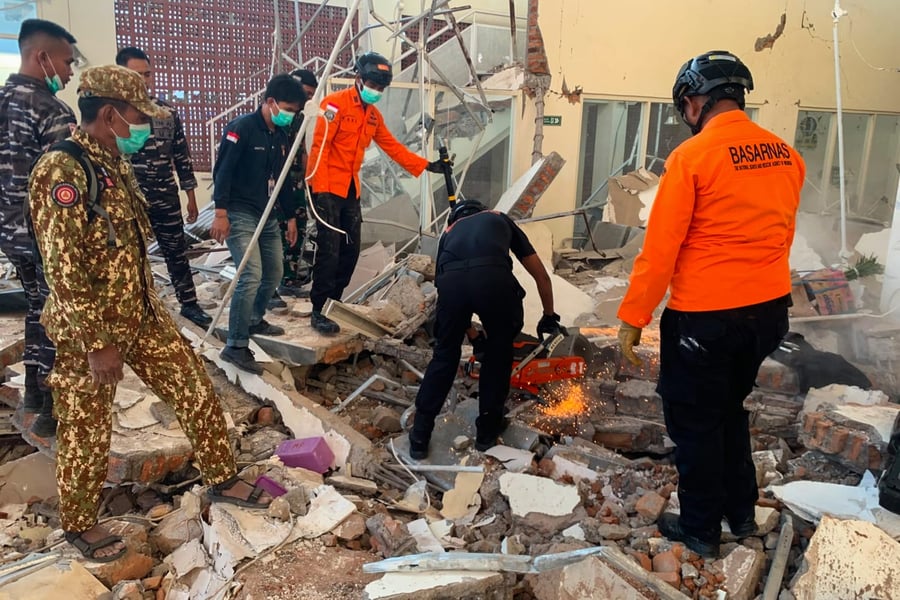 Indonesian rescue workers from BASARNAS search for survivors after the magnitude 7.7 earthquake struck Flores Island