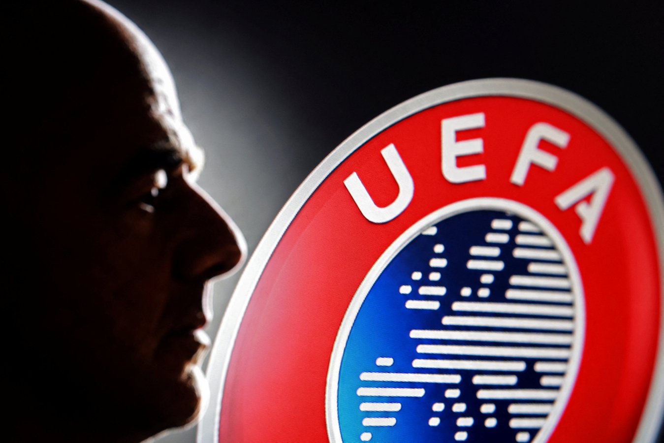 Illustration showing a silhouette of FIFA President Gianni Infantino next to a UEFA logo