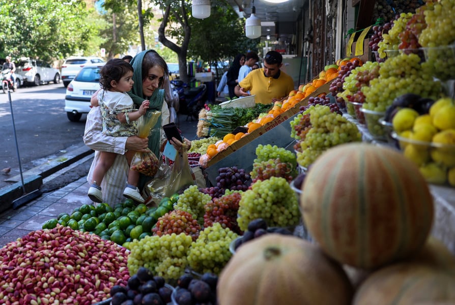 Woman at Tehran market as Iran faces sanctions during Iran-Israel war