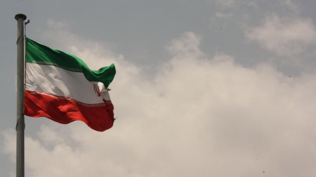 Iranian flag as Tehran escalates its Hormuz vessel blacklisting amid the US sanctions war