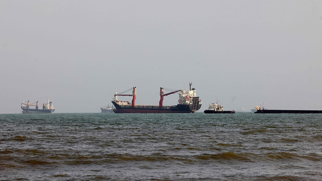 Commercial vessels navigating the Strait of Hormuz near Bandar Abbas Iran amid US sanctions standoff