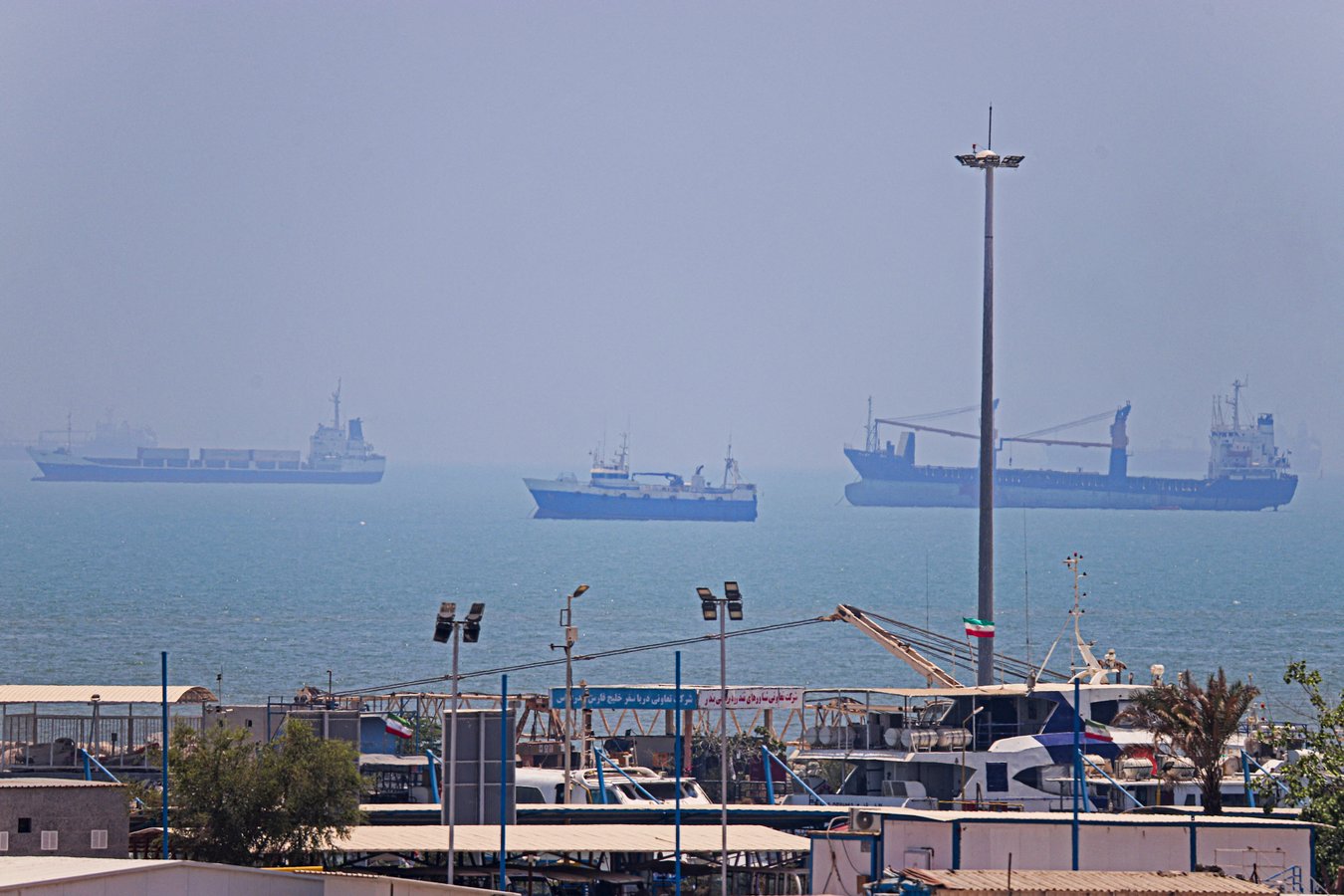 Commercial vessels anchored in Bandar Abbas along the Strait of Hormuz as the US naval blockade of Iran continues