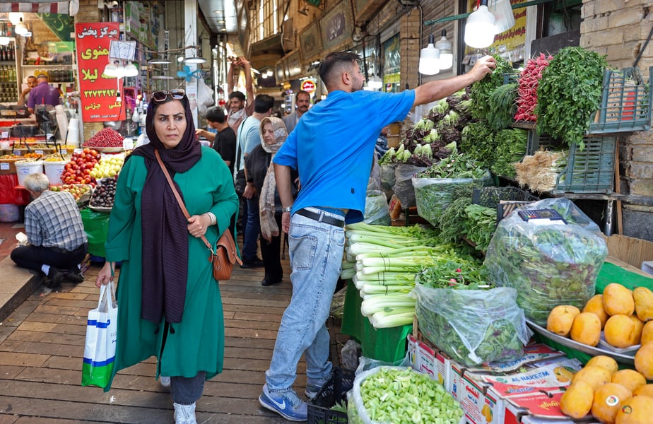 Shoppers browse produce at the historic Tajrish bazaar in northern Tehran amid the economic toll of the Iran war 2026