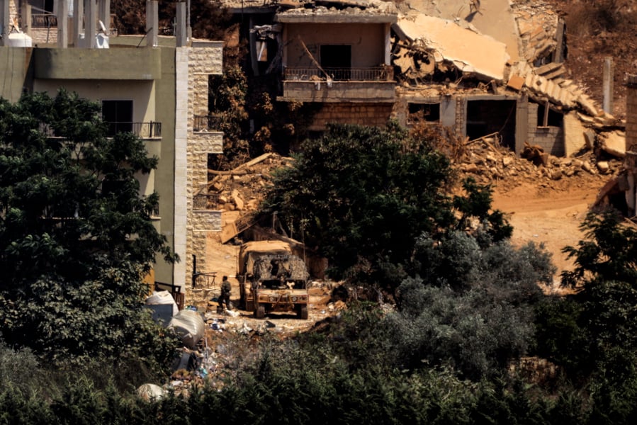 An Israeli military vehicle stationed between houses in the village of Zawtar al-Sharqiyeh in southern Lebanon on August 13, 2026