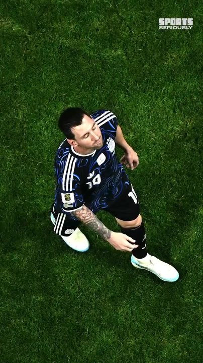 Lionel Messi lies on the pitch in Argentina's away jersey during a match, as Inter Miami mourns the death of his father Jorge Messi