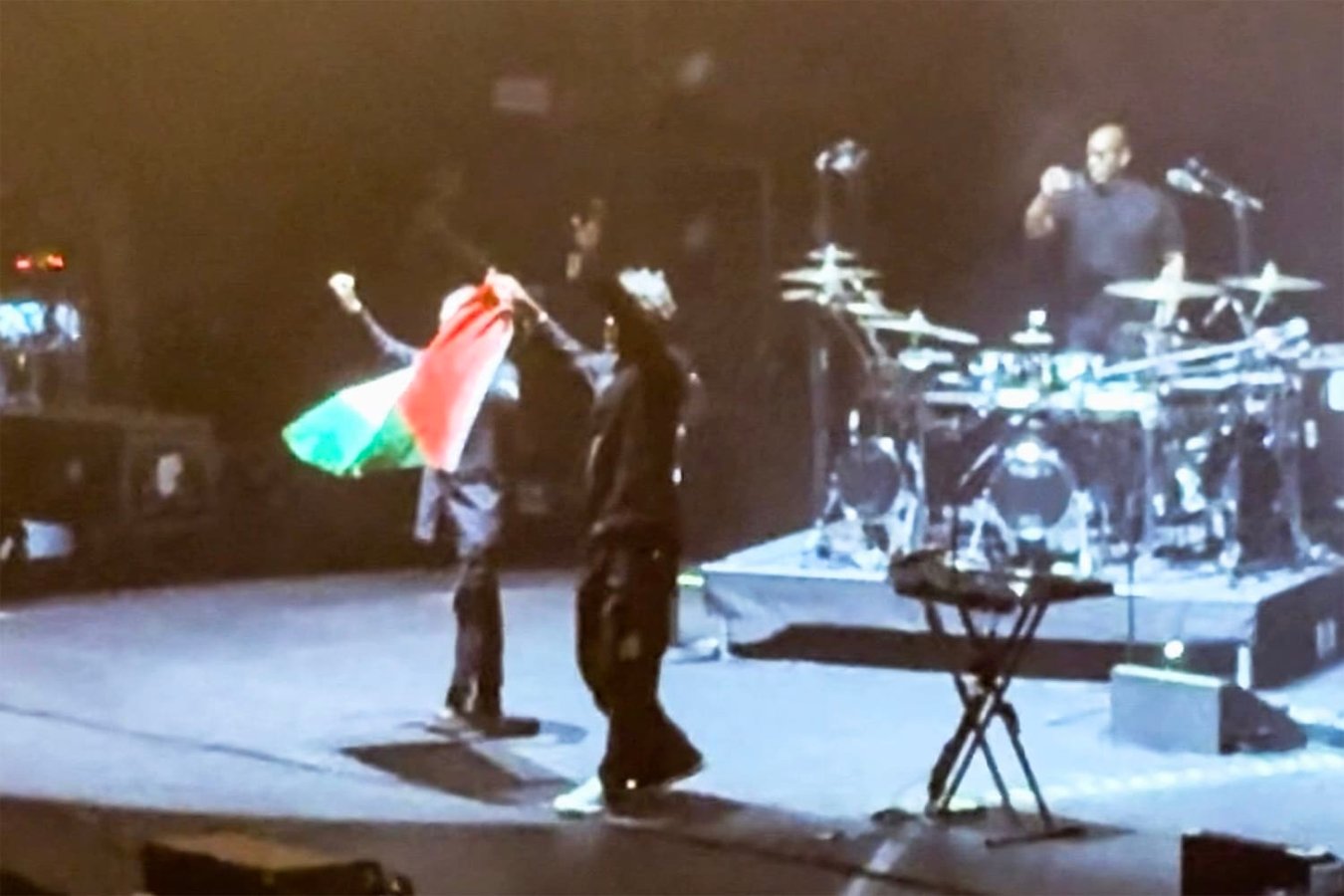 Massive Attack members Robert Del Naja and Grant Marshall perform at a concert before being detained by Singapore police for raising a Palestinian flag