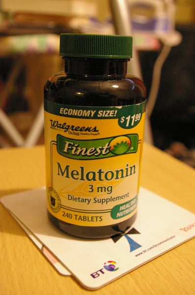 Melatonin supplement bottles on a pharmacy shelf