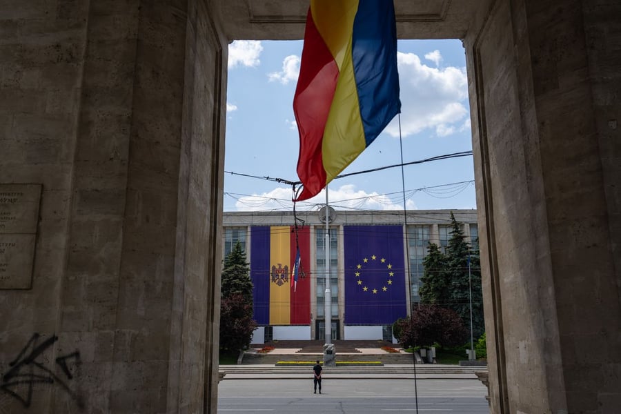 Moldovan and European Union flags displayed at the Government House of Moldova in Chisinau, symbolising the country's EU accession candidacy announced in June 2022