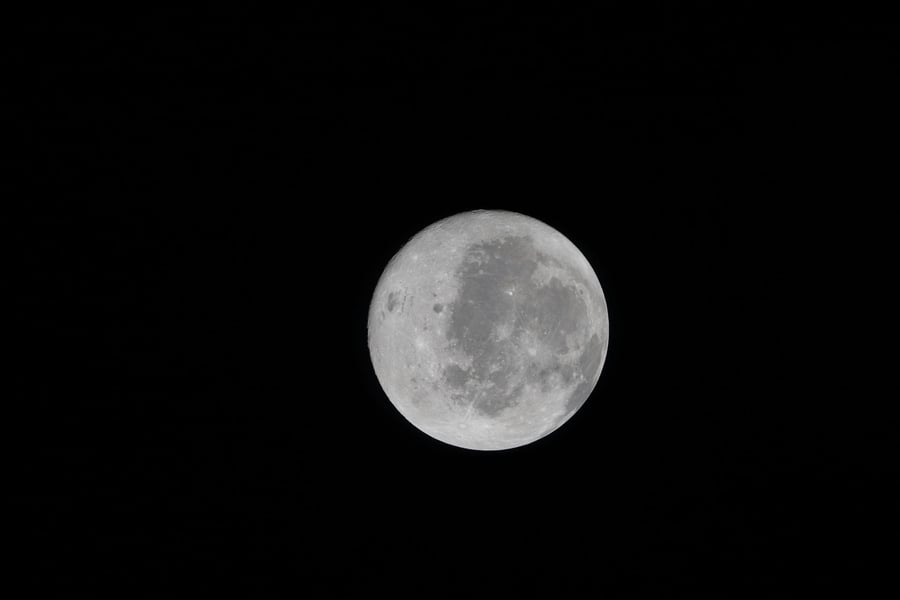 The full nearside of the Moon showing dark lava plains and the bright rays of Tycho crater