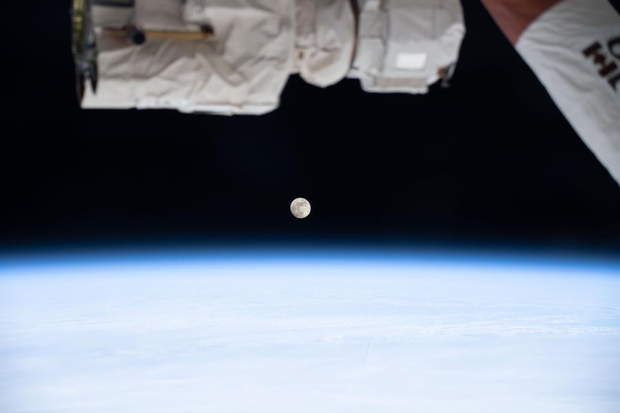 The moon phase today is a waxing gibbous, seen from the International Space Station above the blue band of Earth's atmosphere