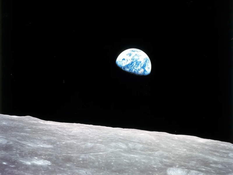 Earthrise as seen from lunar orbit during NASA Apollo 8 mission showing Earth above the Moon surface
