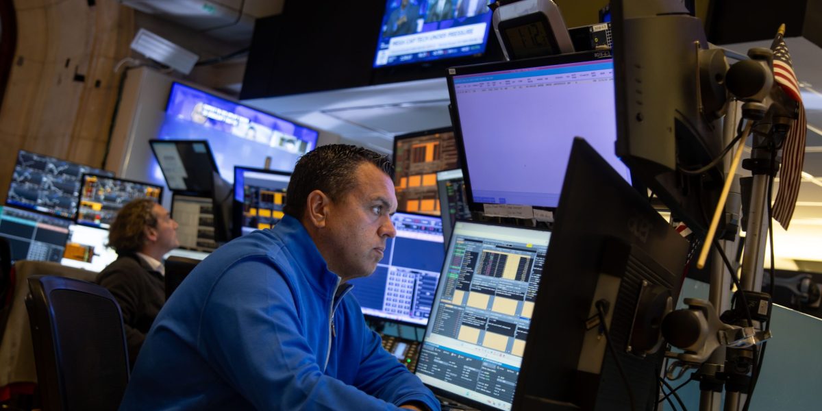 Nasdaq today: traders at work during a session in which the Nasdaq 100 fell, as options markets price technology volatility well above the broad market