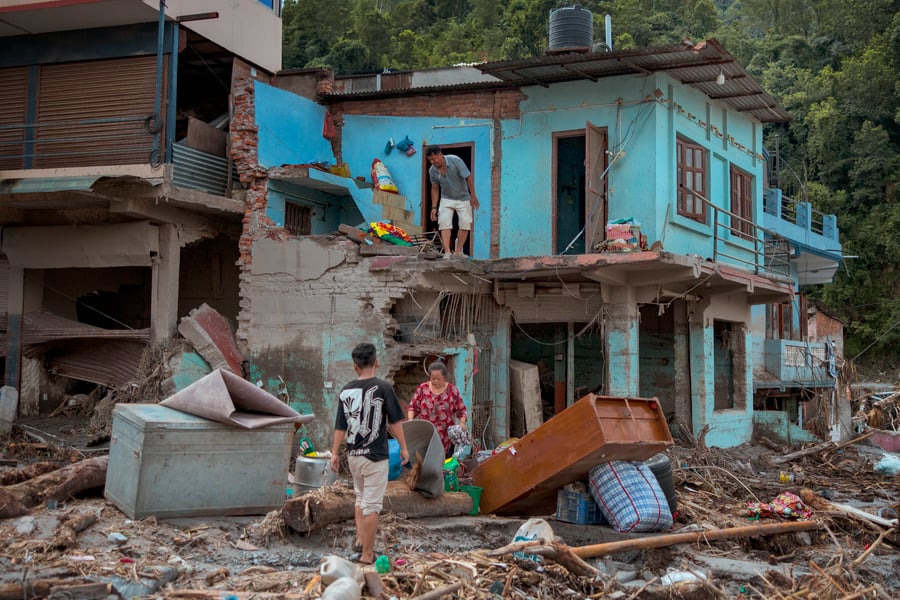 Survivors salvage belongings from destroyed homes in Devighat Nepal after the glacier collapse and flooding near the China-Nepal border August 2026