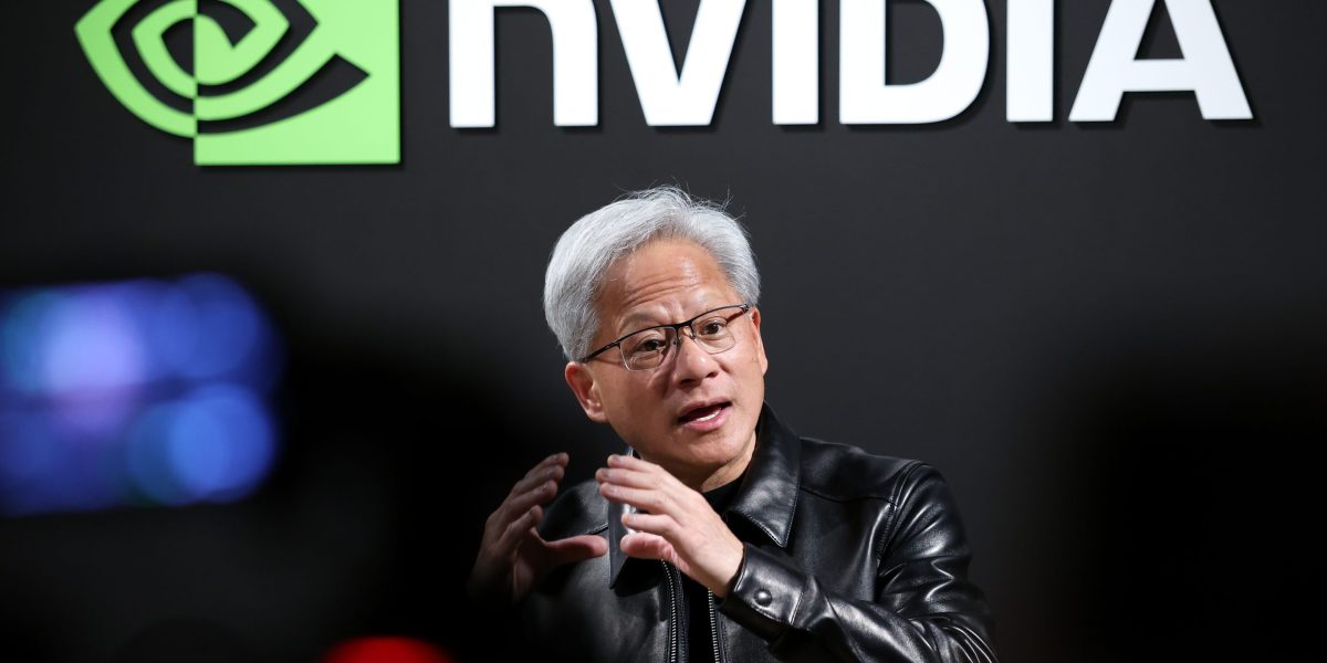 NVDA stock today: Nvidia founder and chief executive Jensen Huang speaking in front of the company logo ahead of second-quarter results