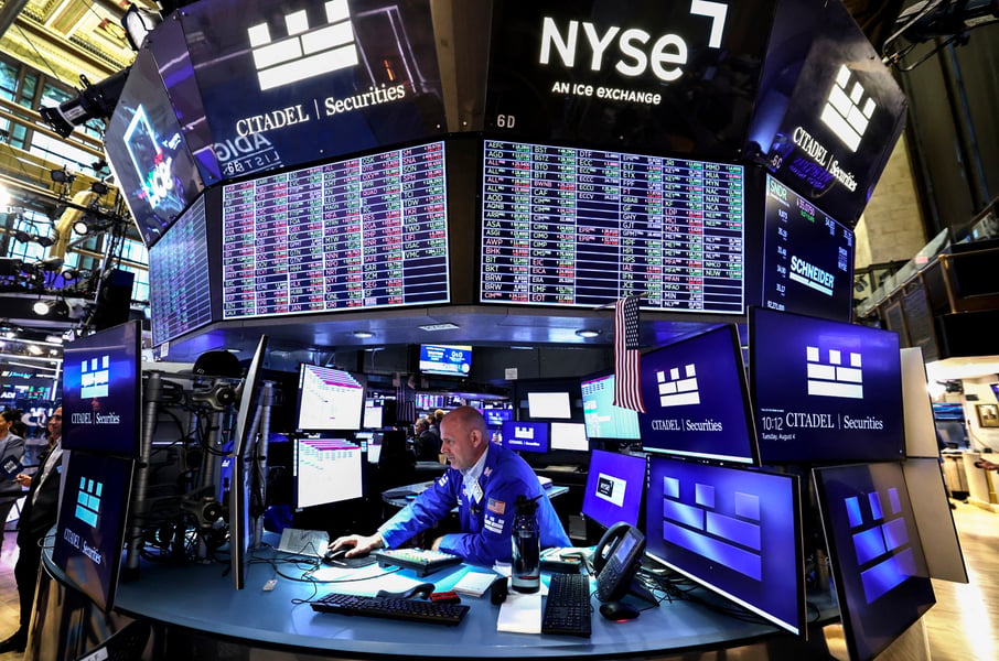 Traders on the floor of the New York Stock Exchange as S&P 500 hits record high on flat July PPI data