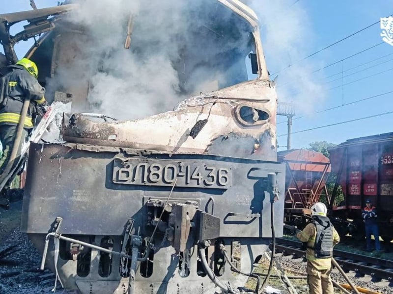 Firefighters extinguish a fire on a train hit by a Russian drone in Ukraine's Odesa region