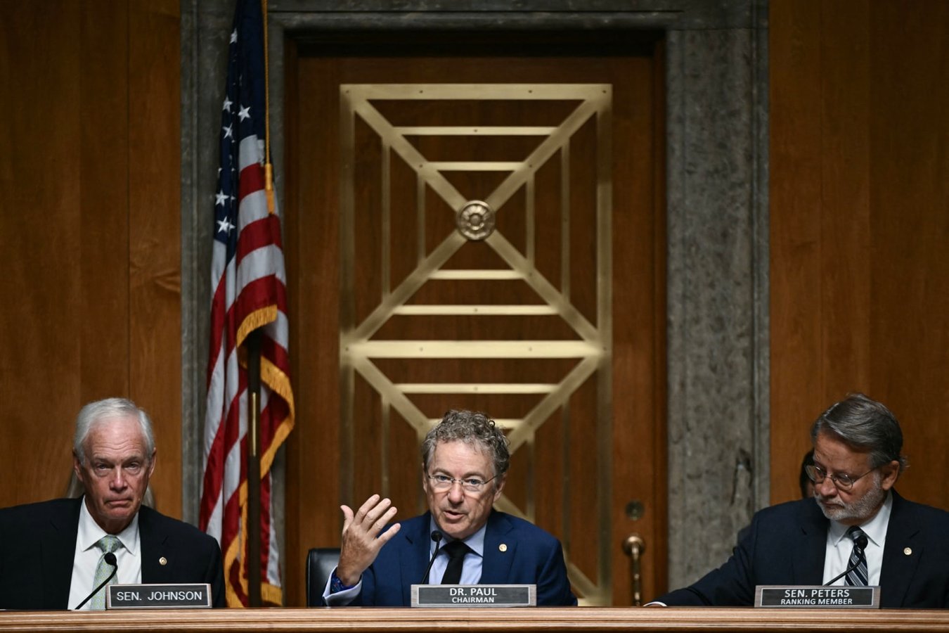 Senator Rand Paul flanked by Ron Johnson and Gary Peters at Senate Fauci contempt vote 2026