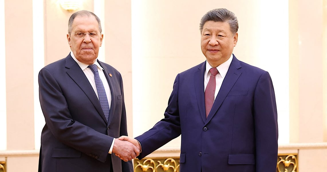 Russian Foreign Minister Sergey Lavrov shakes hands with Chinese President Xi Jinping in Beijing