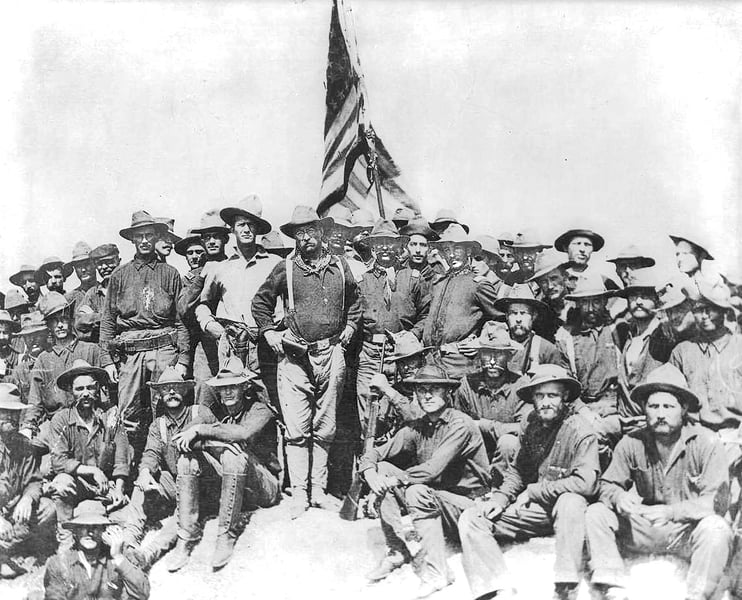 Theodore Roosevelt standing with the Rough Riders on San Juan Heights in Cuba after the charge of 1 July 1898