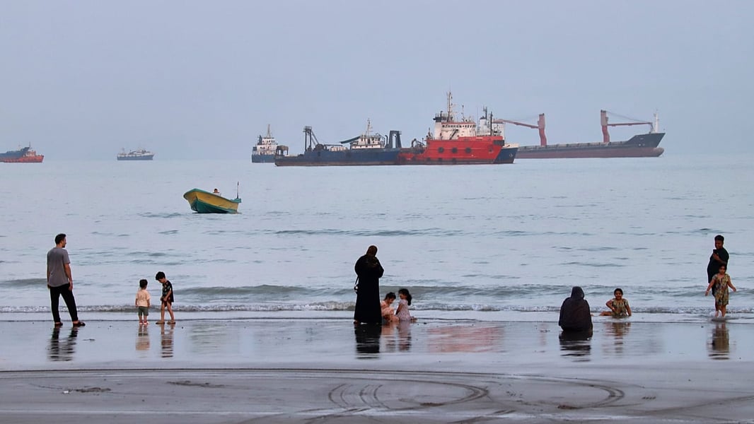 Commercial vessels in the Strait of Hormuz as Trump claims US total control while Iran rejects the assertion
